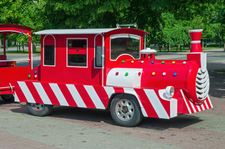 Cheerfully painted childrens train in theme park 摄影